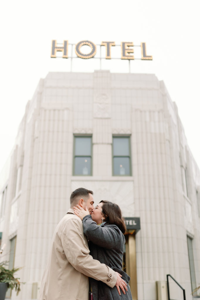 Couple Kissing In Front of Bottleworks Hotel