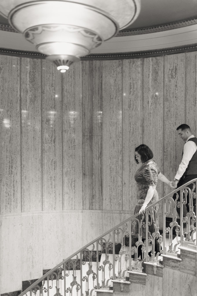 Black and White Photo of Couple Going Down The Stairs at The Bottleworks Hotel