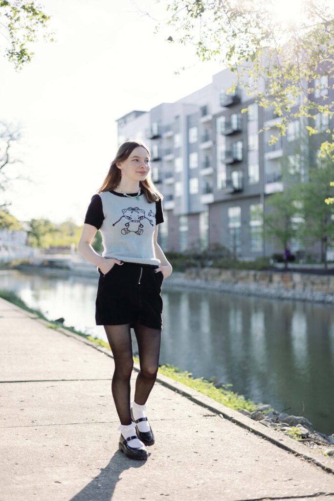 Urban high school senior picture of girl walking along canal in Broad Ripple in Indianapolis
